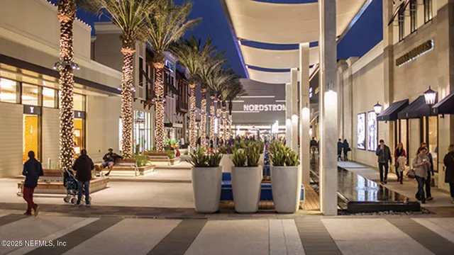 a view of an ocean light and house in the background