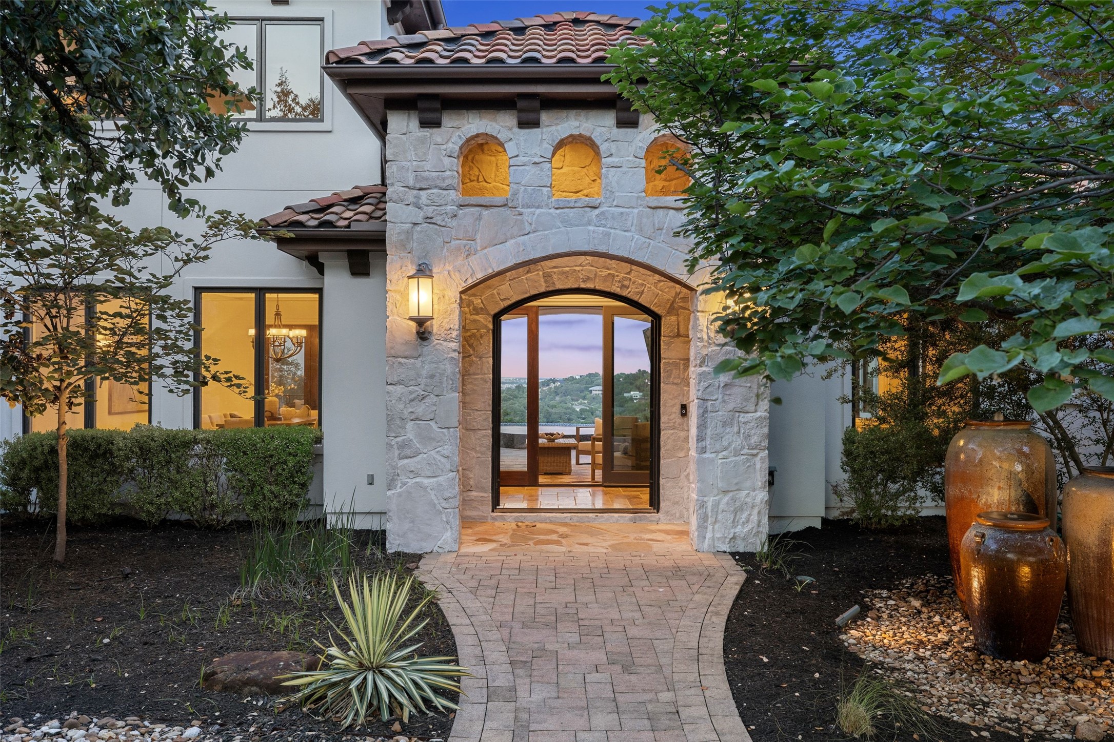 1414 The High Road Austin, TX 78746 - Photo 7 of 40 Stone archway entry beckons into a home with a breathtaking water view.