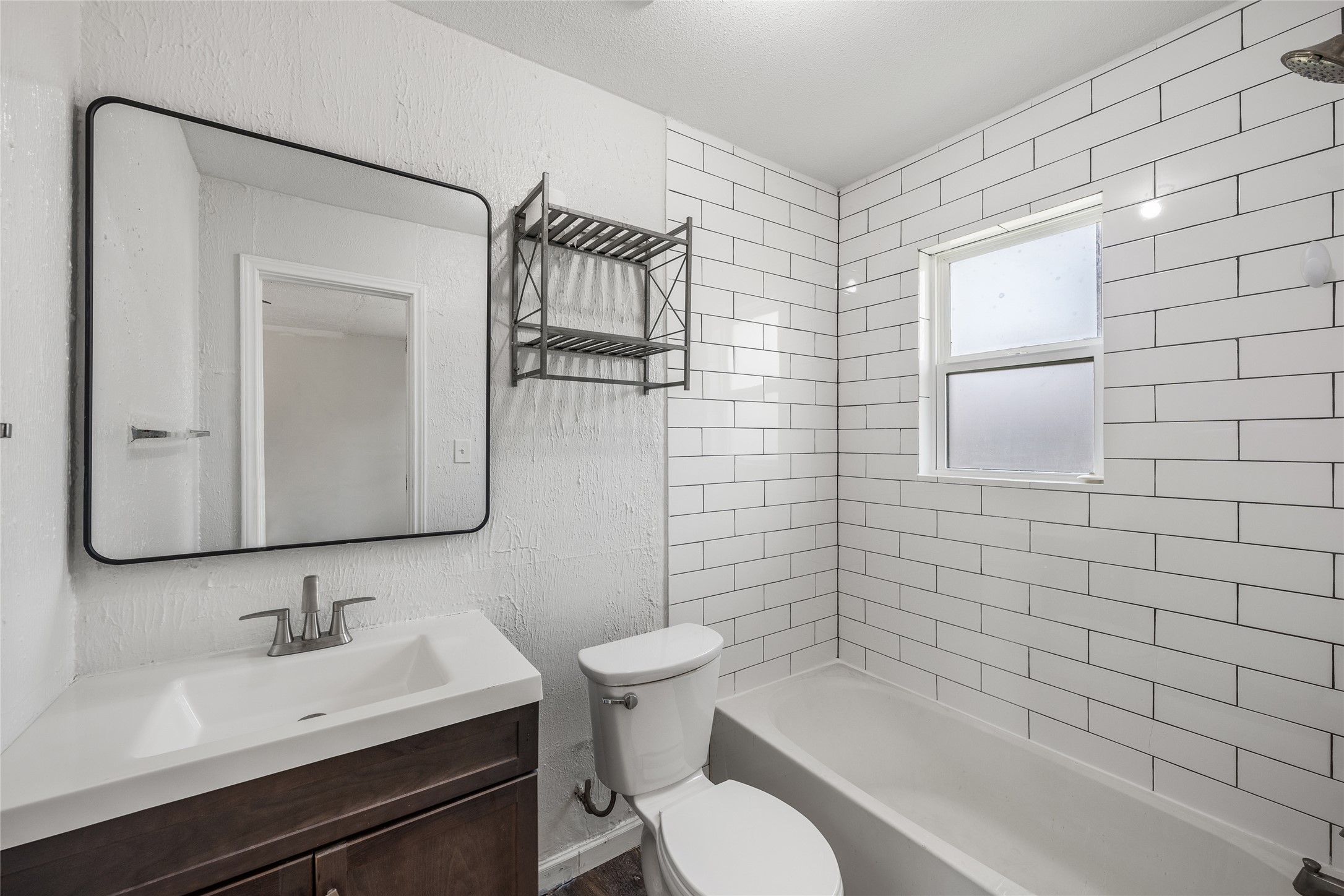 1116 Ebert Avenue, Unit B Austin, TX 78721 - Photo 12 of 28 a bathroom with a toilet a sink a mirror and shower