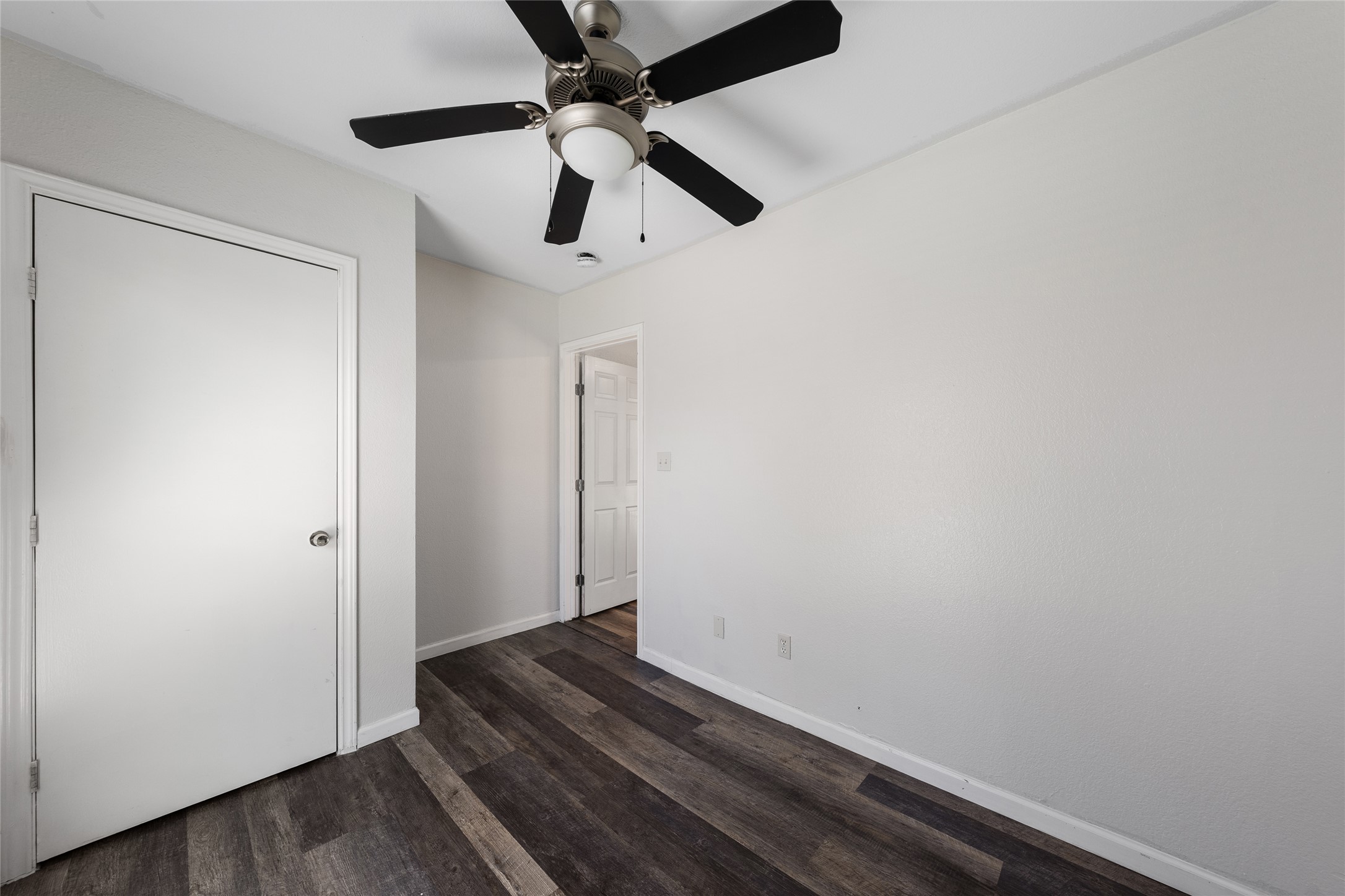 1116 Ebert Avenue, Unit B Austin, TX 78721 - Photo 14 of 28 a room with wooden floor and ceiling fan