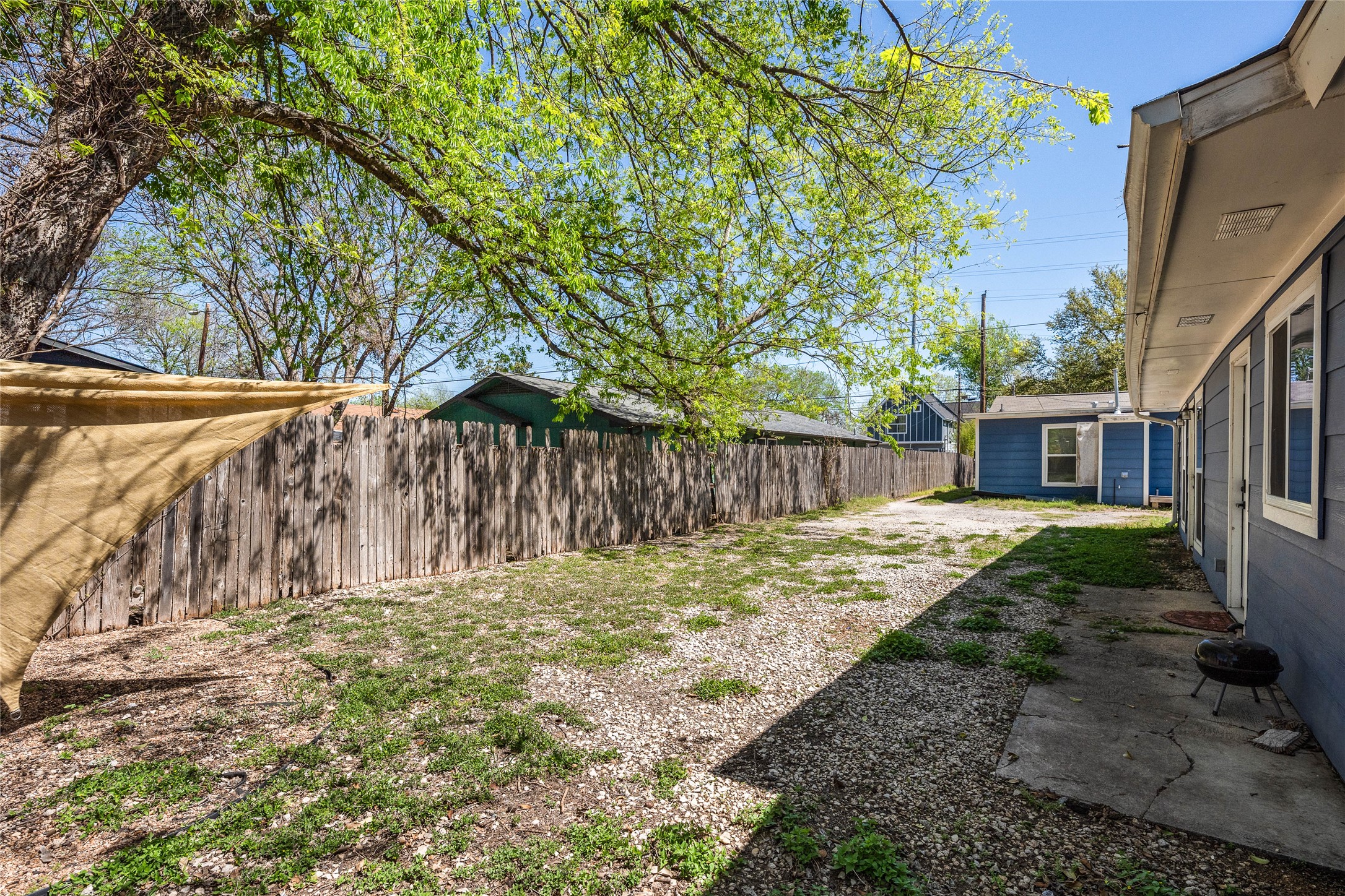 1116 Ebert Avenue, Unit B Austin, TX 78721 - Photo 28 of 28 a backyard of a house with large trees and wooden fence