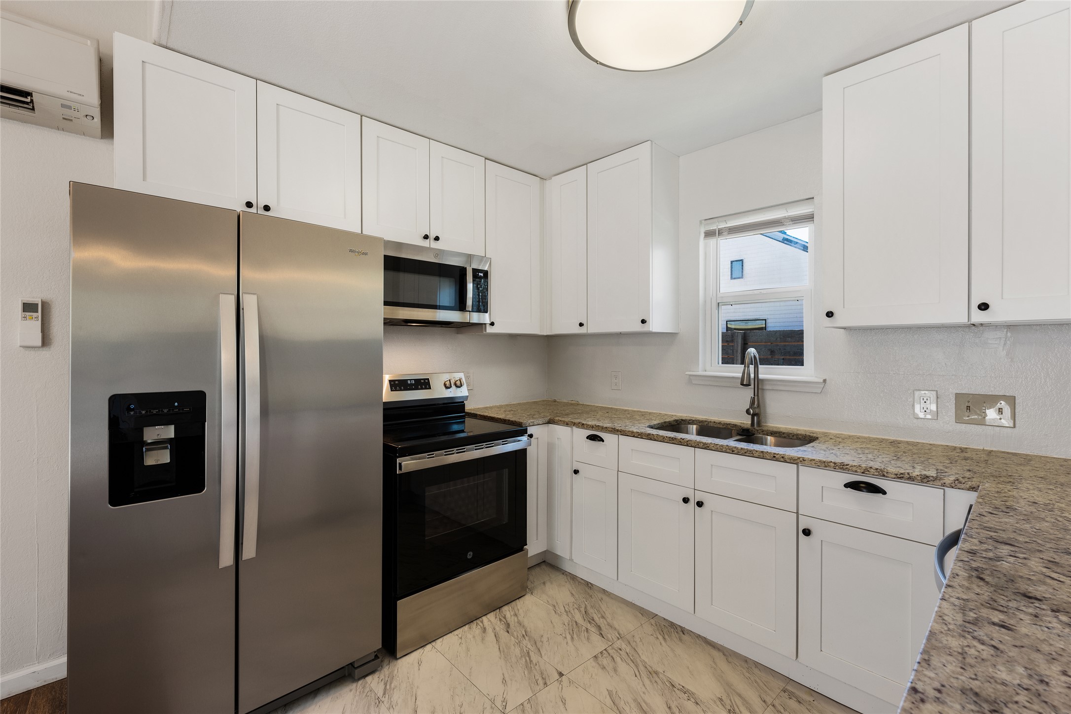 1116 Ebert Avenue, Unit B Austin, TX 78721 - Photo 4 of 28 a kitchen with stainless steel appliances granite countertop a refrigerator sink and cabinets