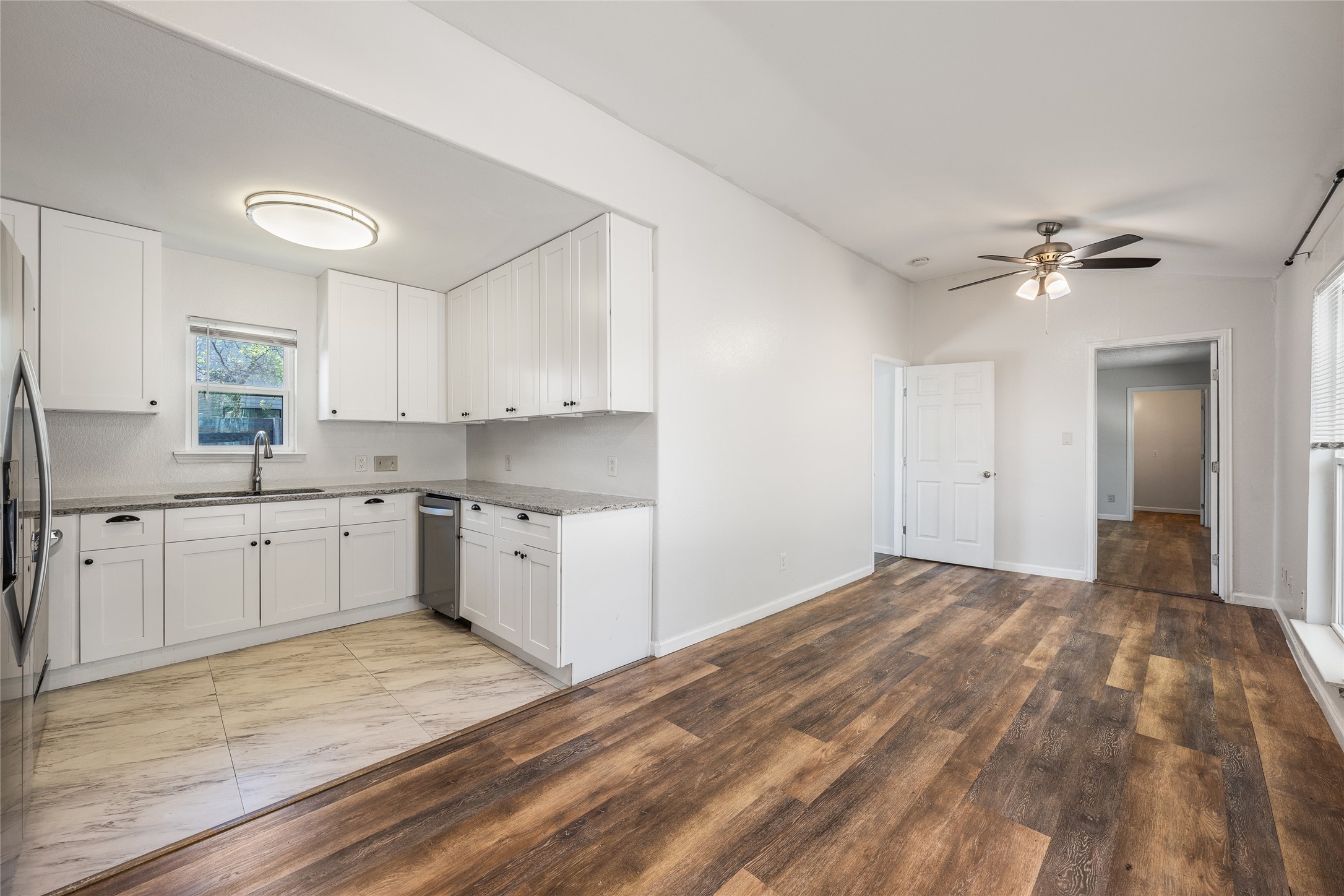 1116 Ebert Avenue, Unit B Austin, TX 78721 - Photo 7 of 28 a kitchen with granite countertop a sink cabinets stainless steel appliances and a window