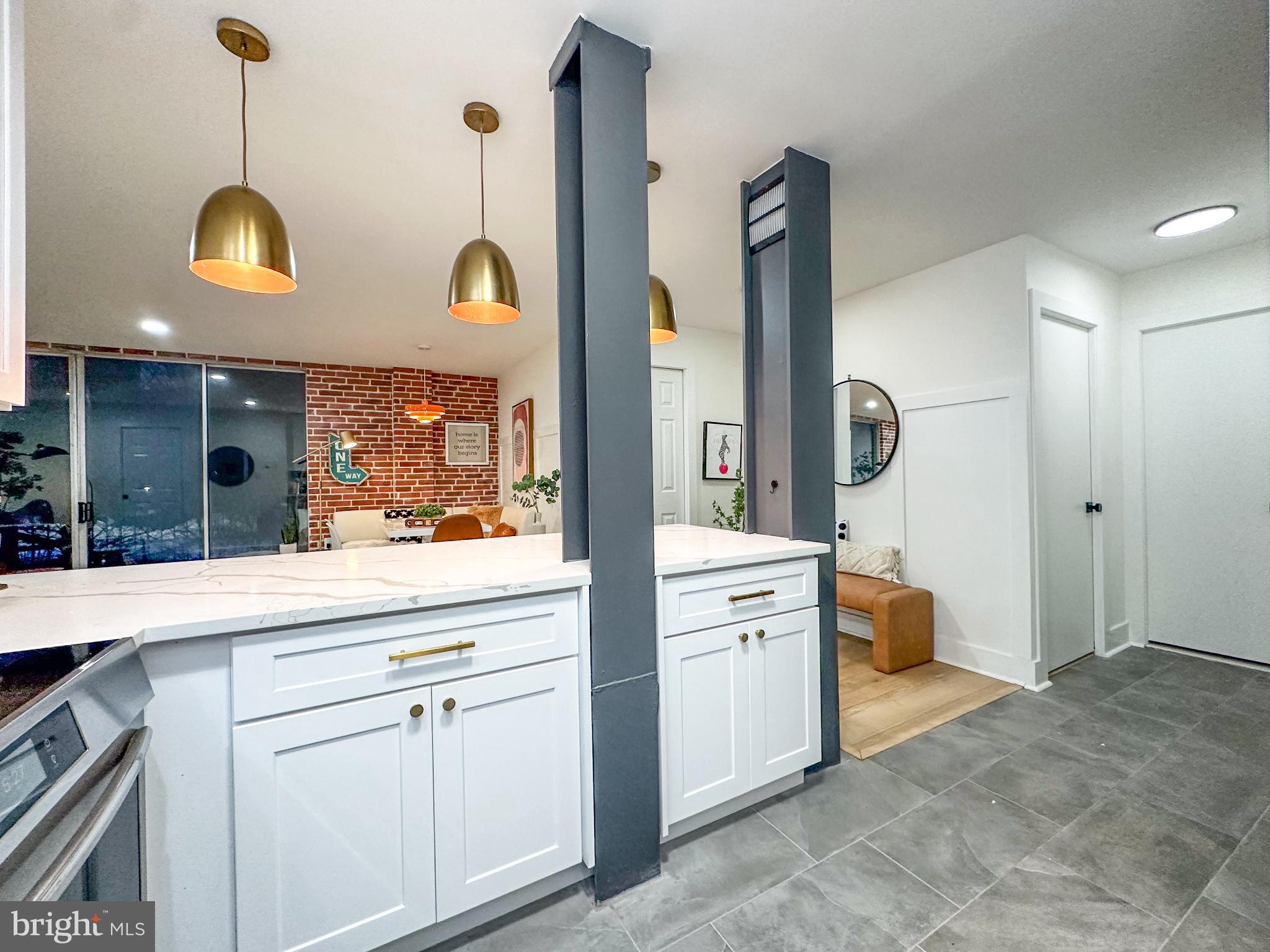3245 Rio Drive, Unit 206 Falls Church, VA 22041 - Photo 13 of 36 a open kitchen with stainless steel appliances granite countertop a stove a refrigerator and a wooden floor