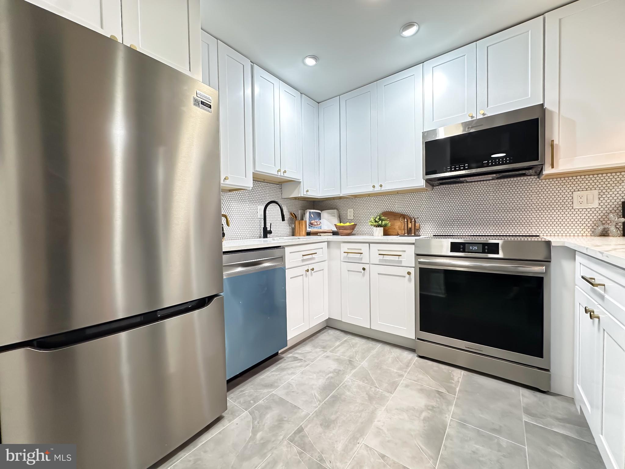 3245 Rio Drive, Unit 206 Falls Church, VA 22041 - Photo 16 of 36 a kitchen with a refrigerator sink and microwave