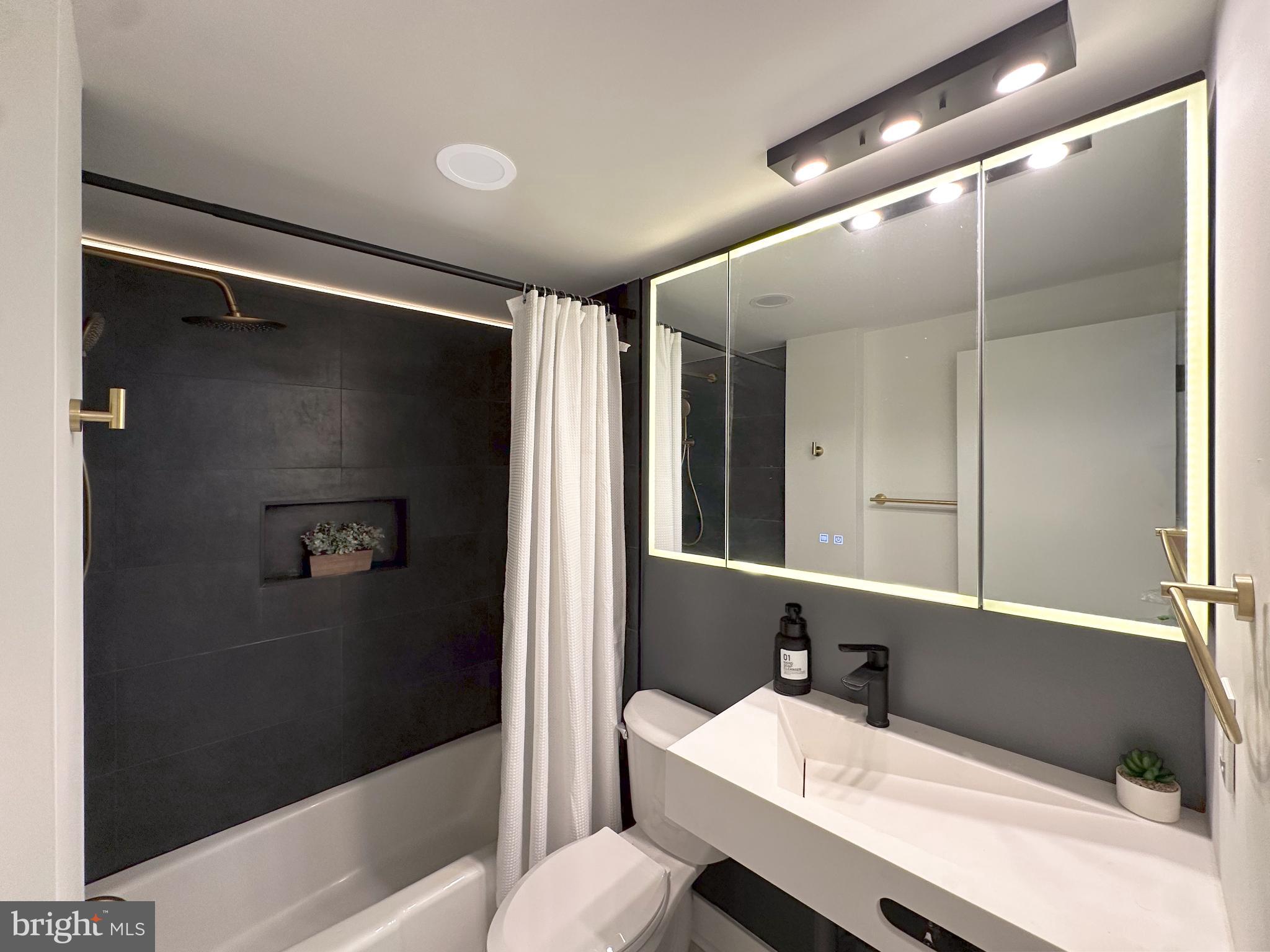 3245 Rio Drive, Unit 206 Falls Church, VA 22041 - Photo 19 of 36 a bathroom with a sink and a mirror