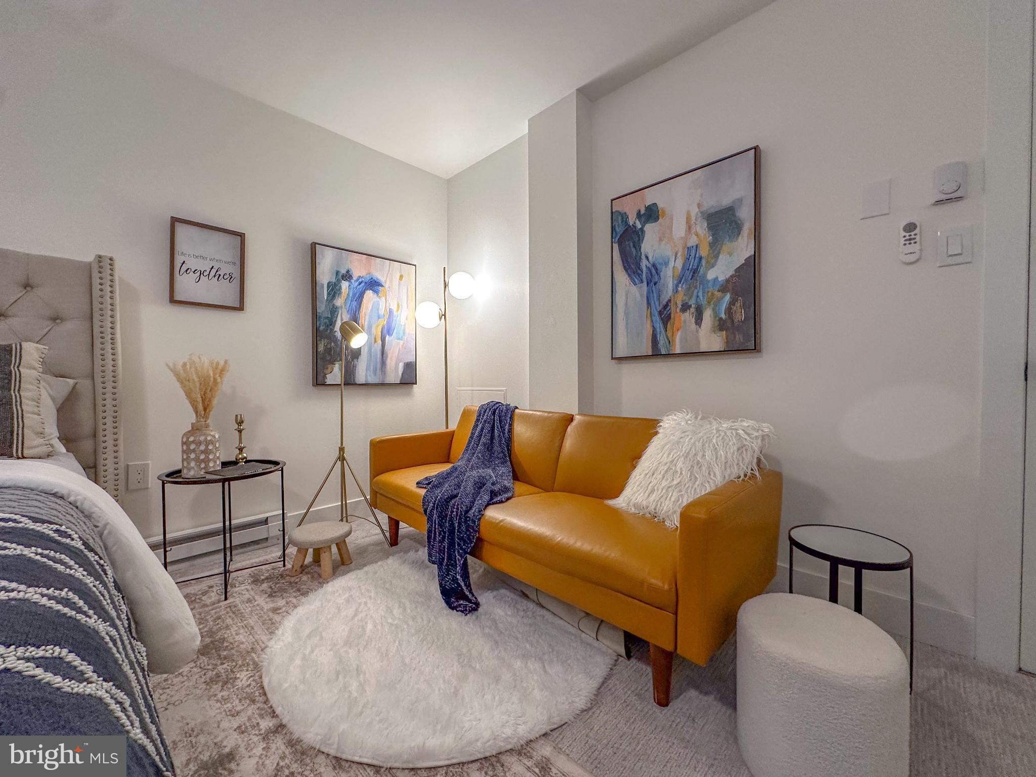 3245 Rio Drive, Unit 206 Falls Church, VA 22041 - Photo 21 of 36 a living room with furniture and a blue wall