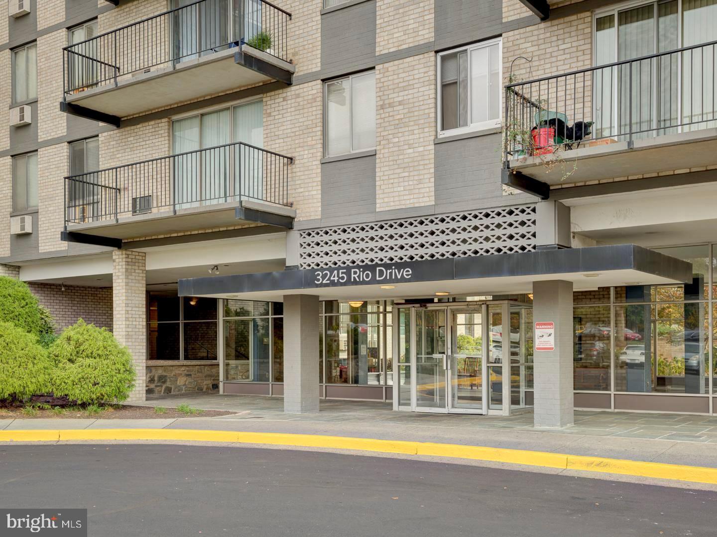 3245 Rio Drive, Unit 206 Falls Church, VA 22041 - Photo 30 of 36 a view of a white building with swimming pool in front of it