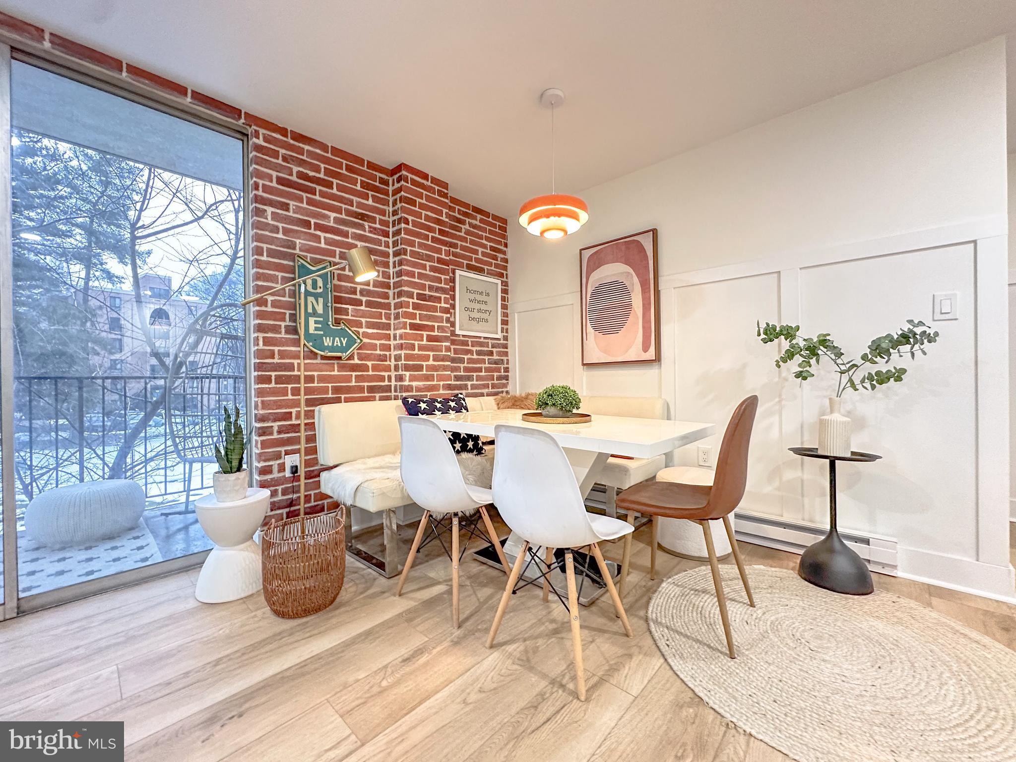3245 Rio Drive, Unit 206 Falls Church, VA 22041 - Photo 4 of 36 a view of a dining room with furniture a chandelier and wooden floor