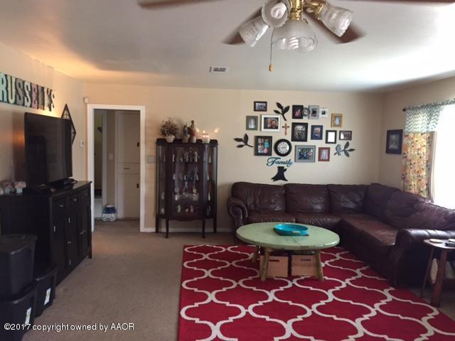 4317 South Travis Street Amarillo, TX 79110 - Photo 2 of 20 a living room with furniture a rug and a window