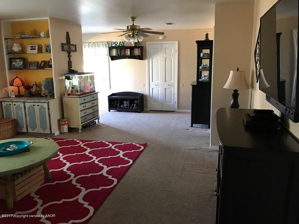 4317 South Travis Street Amarillo, TX 79110 - Photo 3 of 20 a living room with furniture and a flat screen tv