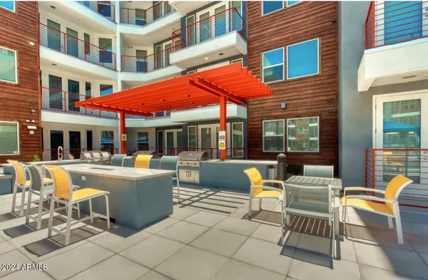 a view of a patio with a dining table and chairs