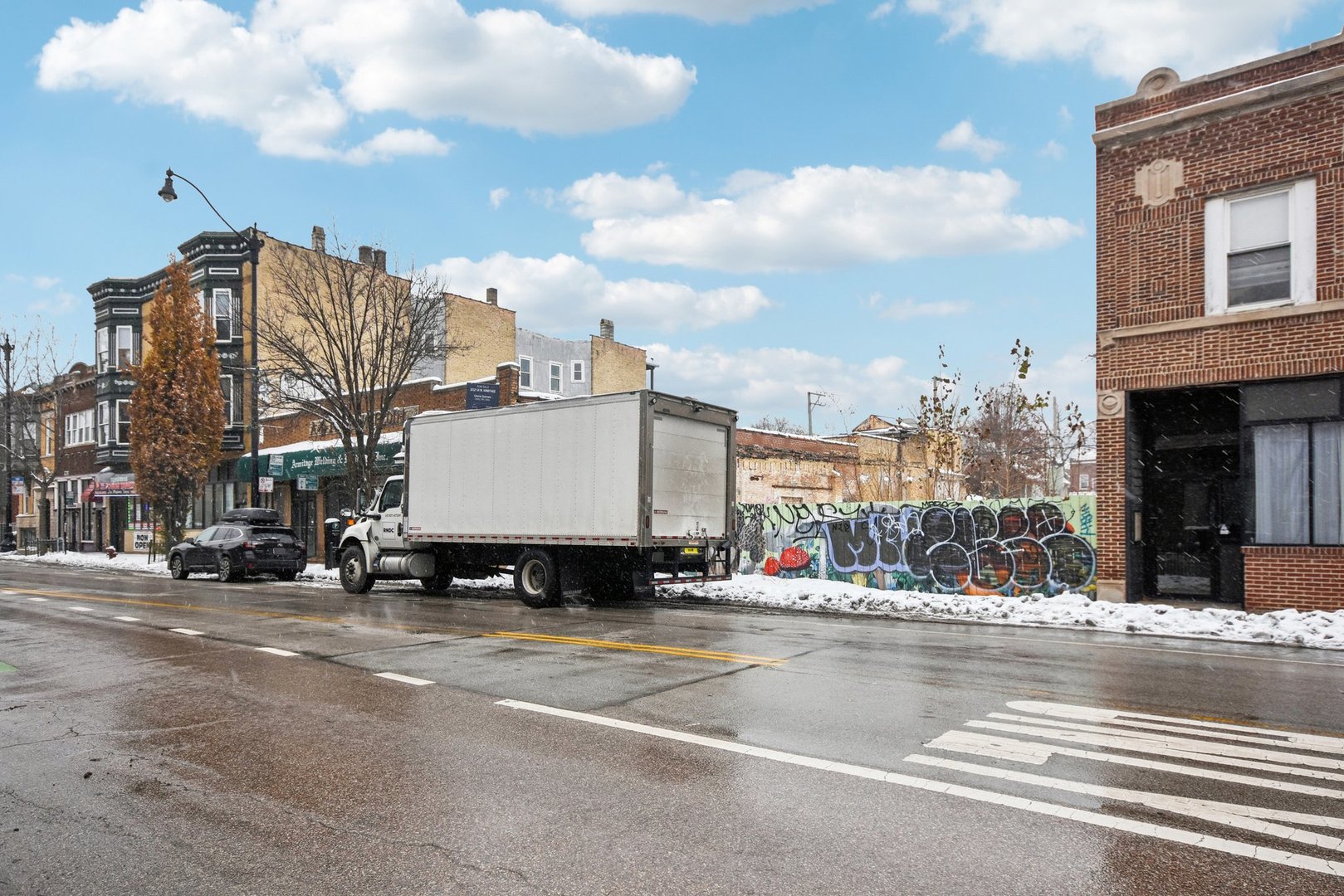 3212 West Armitage Avenue Chicago, IL 60647 - Photo 3 of 9 a view of a city street lined with tall buildings