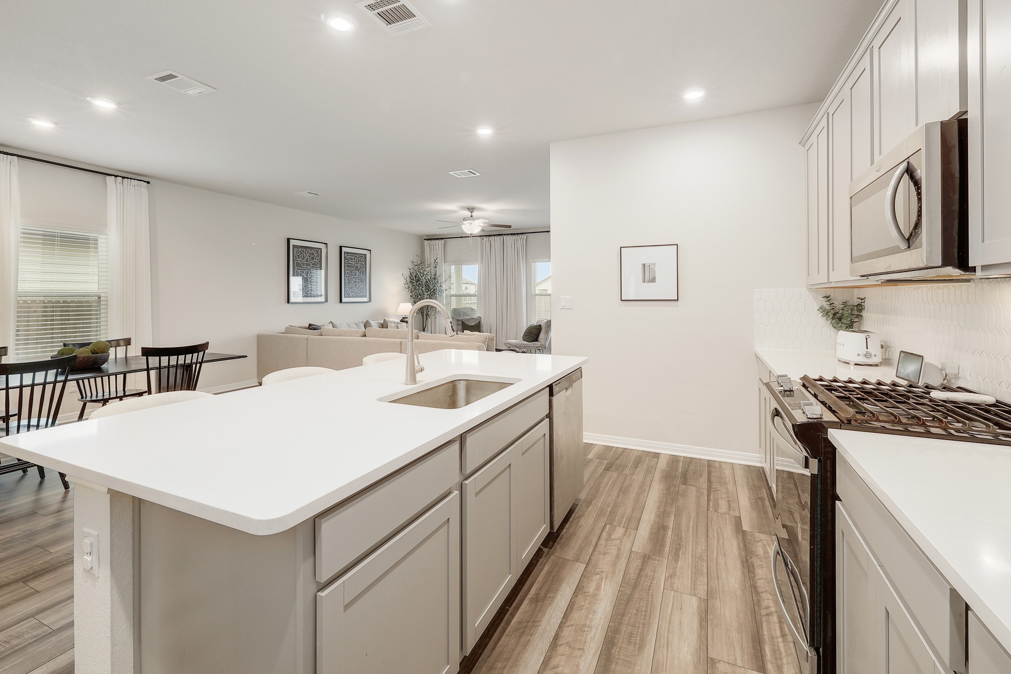144 Sungrove Trail Georgetown, TX 78628 - Photo 8 of 40 A luxe backsplash and single basin undermount sink add to the modern feel of the kitchen