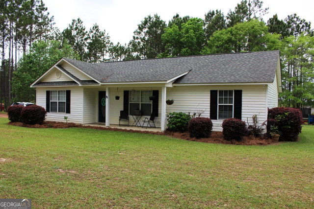 38 Oak View Road Hazlehurst, GA 31539 - Photo 1 of 1 a front view of a house with a garden and yard