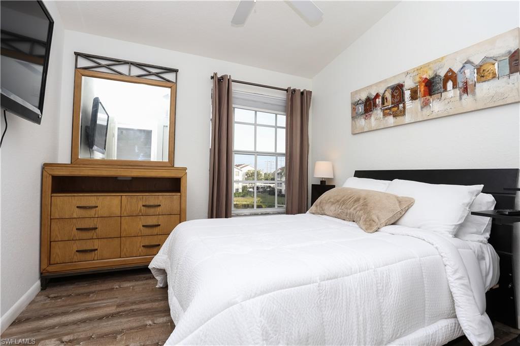 4650 St Croix Lane, Unit 731 Naples, FL 34109 - Photo 14 of 29 a bedroom with a bed and a dresser