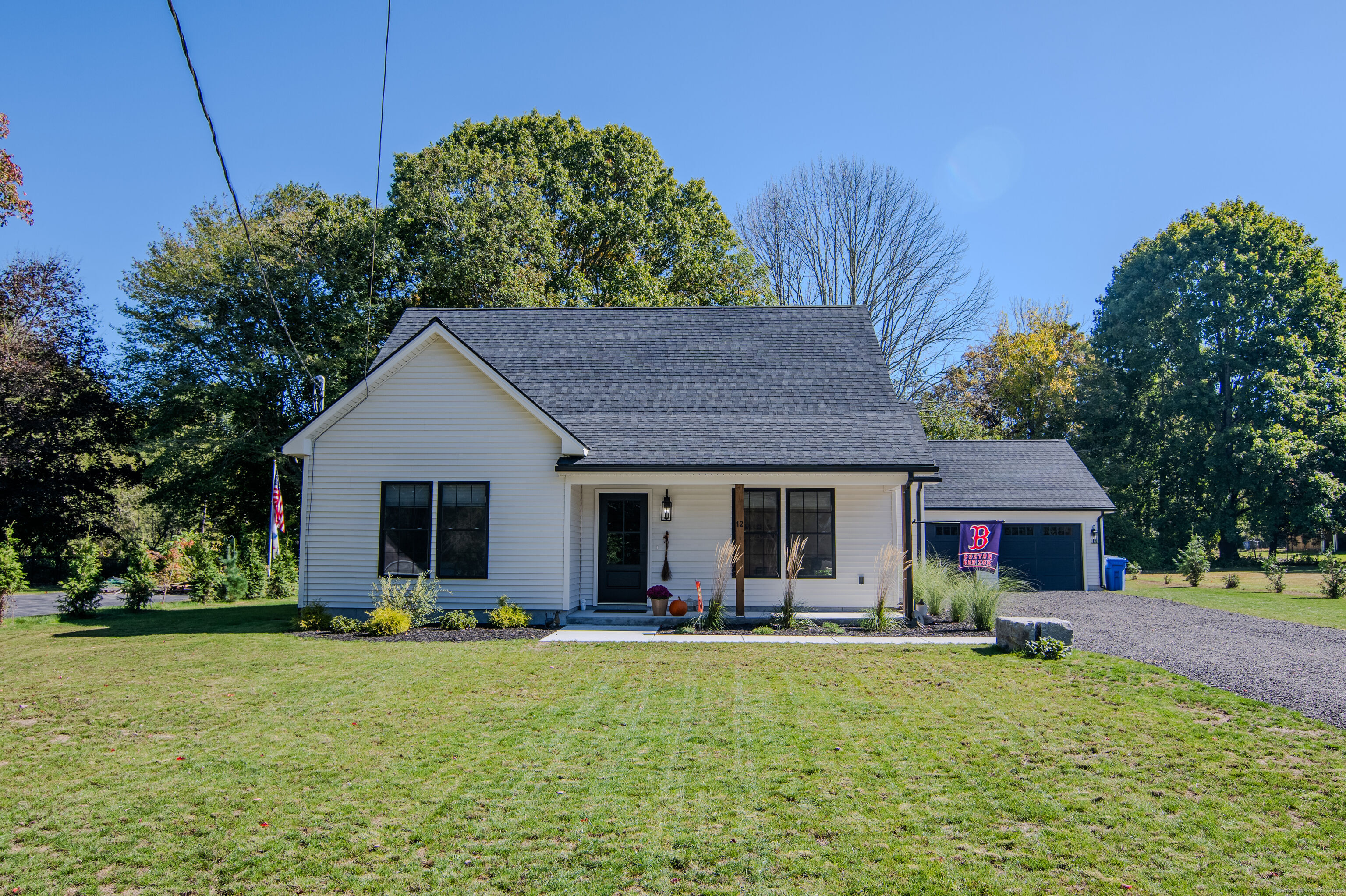 a front view of house with yard and green space