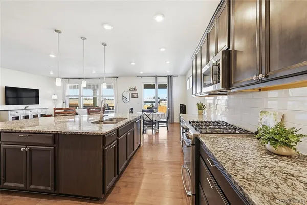 a view of a dining room with furniture and wooden floor