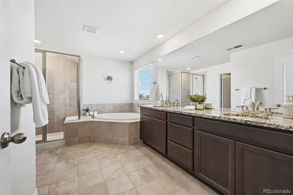 a en suite bathroom with a sink mirror and a toilet
