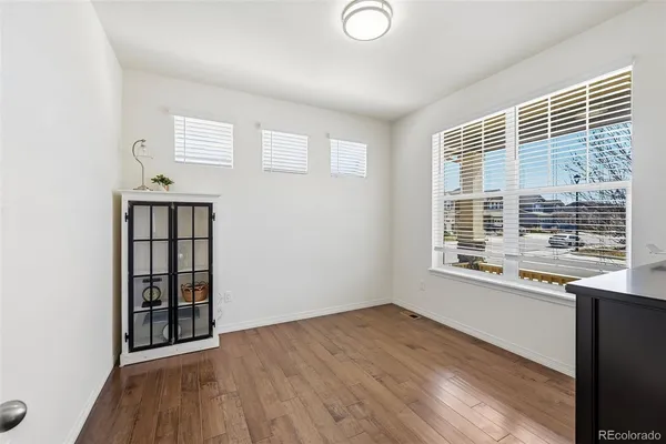 a view of a dining room with furniture window and wooden floor