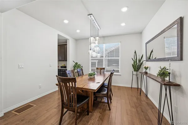 a view of a dining room with furniture and wooden floor
