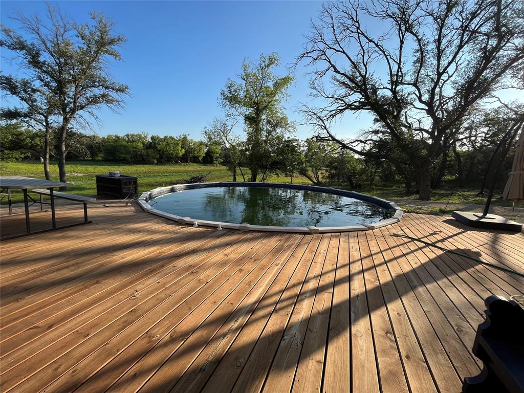 125 Drake Court Comanche, TX 76442 - Photo 12 of 35 a view of a swimming pool with a patio