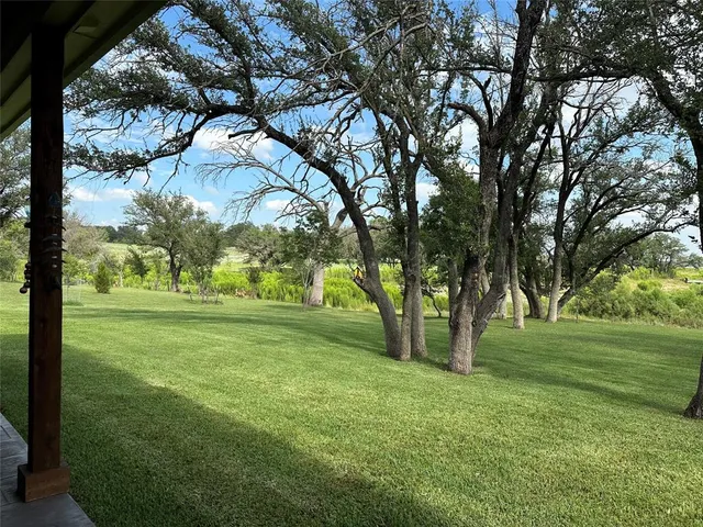 a spacious bedroom with a large bed and a large window