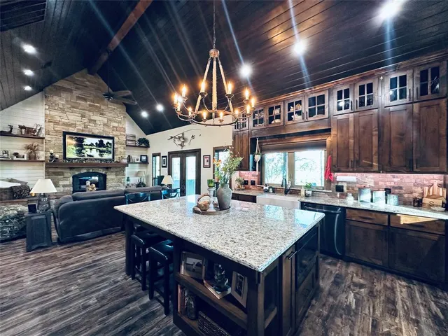 a living room with fireplace furniture and a flat screen tv