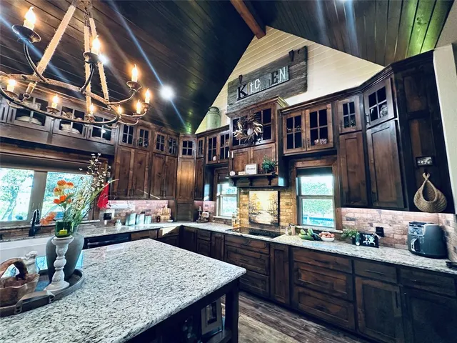 a living room with lots of furniture and kitchen view