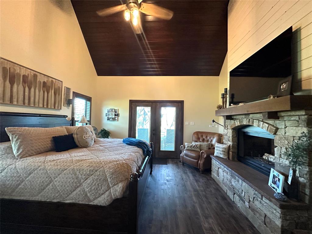 125 Drake Court Comanche, TX 76442 - Photo 3 of 35 a bedroom with a bed and a fireplace