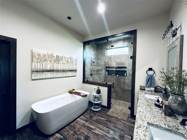 a bathroom with a granite countertop sink toilet and shower