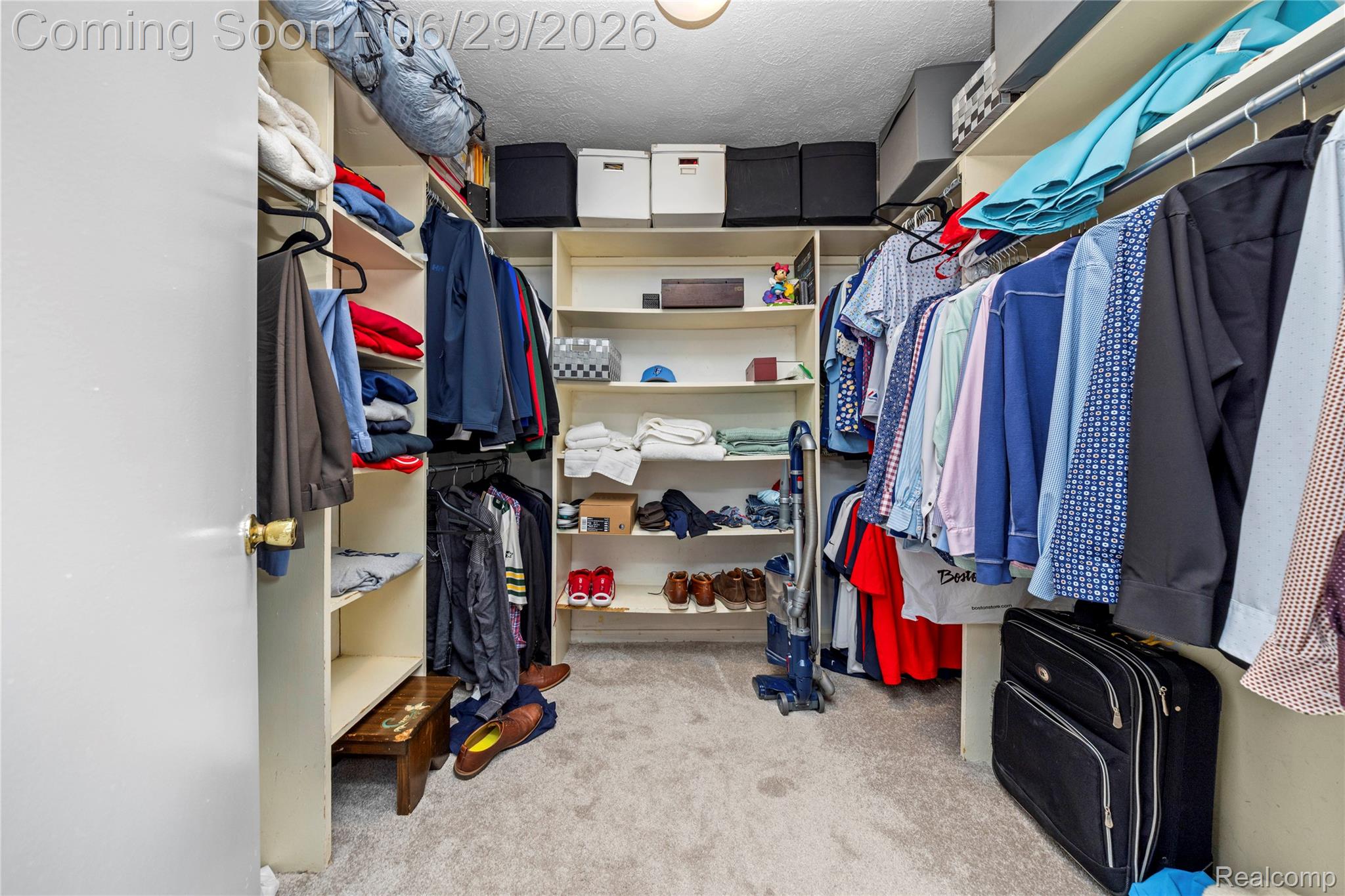 6085 Worlington Road Bloomfield Hills, MI 48301 - Photo 38 of 75 Carpeted walk-in closet featuring extensive built-in shelving, multiple hanging rods, and recessed ceiling lighting