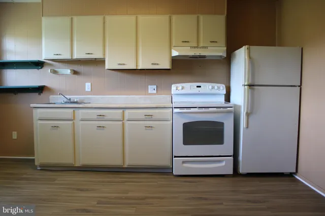 a kitchen with granite countertop cabinets stainless steel appliances and a sink