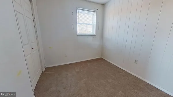 a view of a small space with wooden floor and a window
