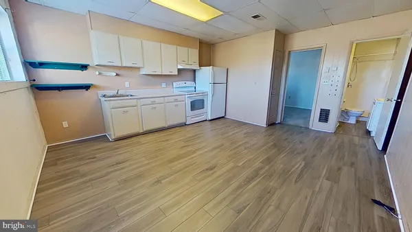 a view of a kitchen with wooden floor