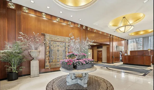 a living room with furniture and flowers