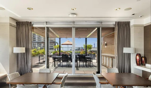 a view of a livingroom with furniture and floor to ceiling window