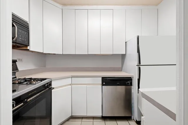 a living room with furniture a couch and next to a window