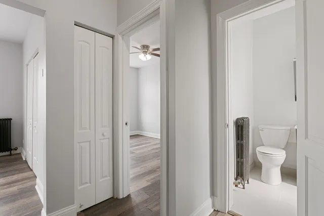 a bathroom with a granite countertop toilet a sink and a mirror