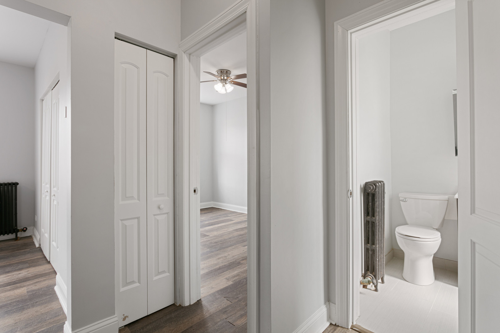 1608 West Sherwin Avenue, Unit 412 Chicago, IL 60626 - Photo 7 of 11 a bathroom with a granite countertop toilet a sink and a mirror