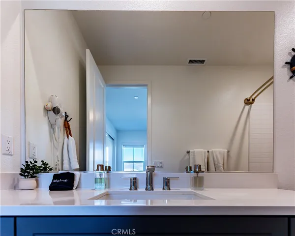 a bedroom with a bed and a night stand