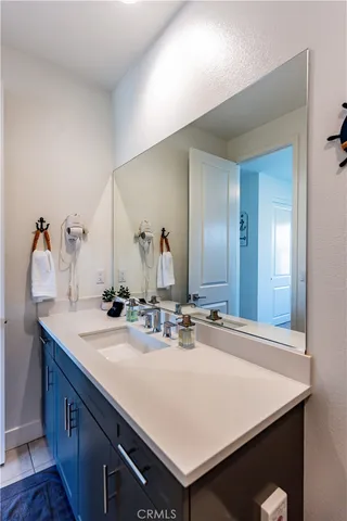 a bed sitting in a bedroom next to a lamp