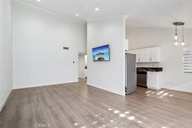 a view of a kitchen with a sink and a refrigerator