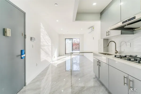 a kitchen with a stove a refrigerator and cabinets