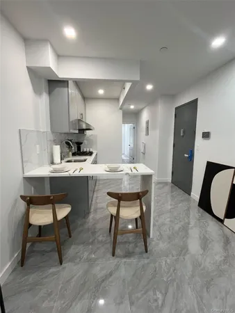 a kitchen with a sink cabinets and wooden floor