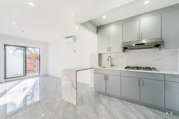 a kitchen with white cabinets and sink