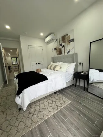 a large bedroom with a bed and a table in it