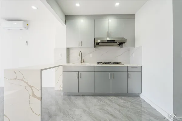 a kitchen with kitchen island cabinets and appliances