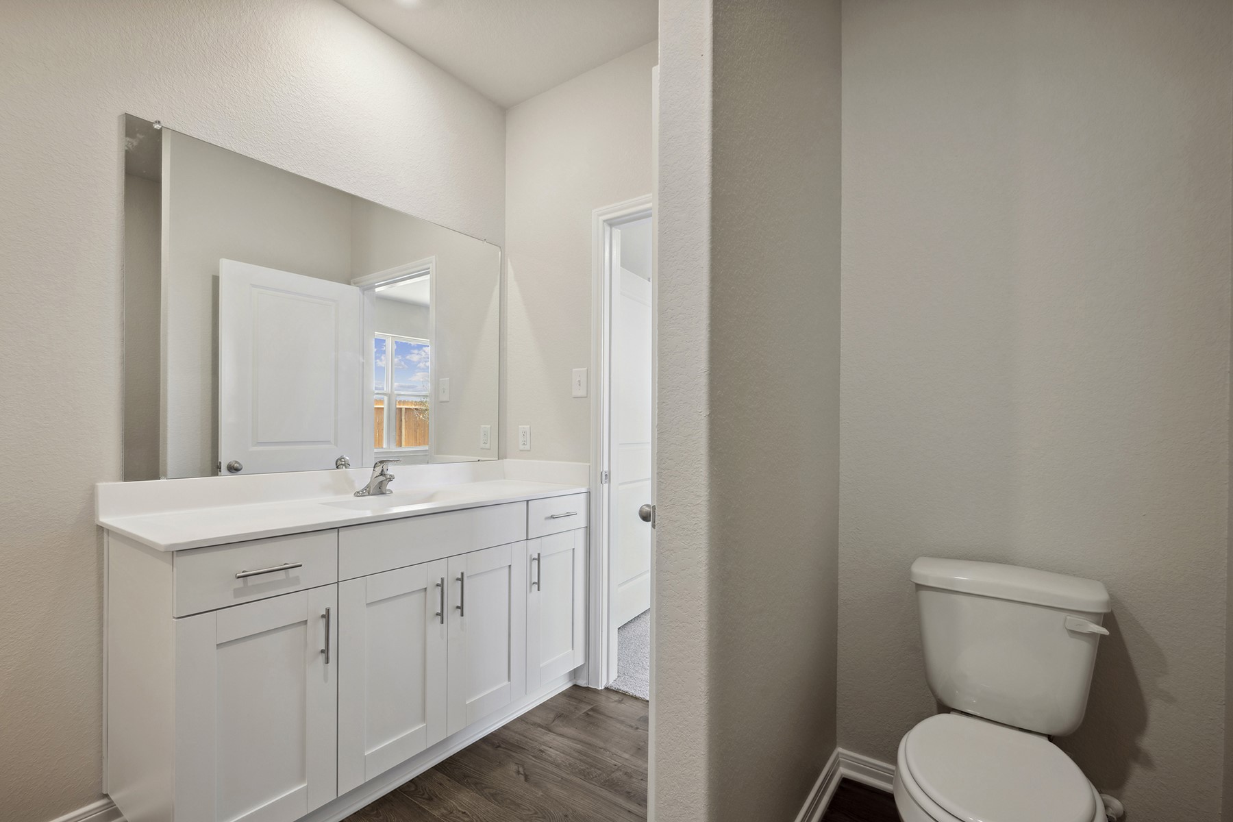 10422 Red Cardinal Drive Cleveland, TX 77328 - Photo 13 of 23 a bathroom with a toilet a sink and mirror