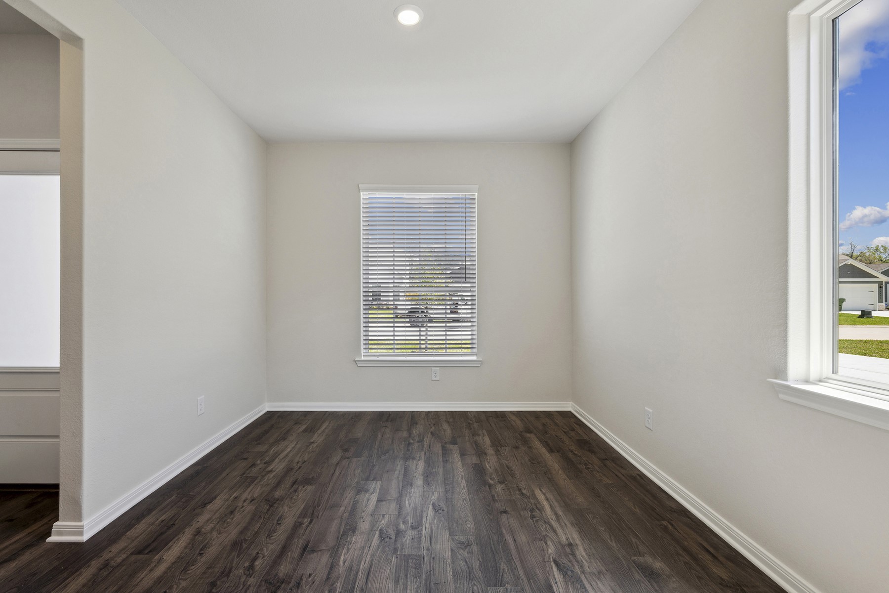 10422 Red Cardinal Drive Cleveland, TX 77328 - Photo 4 of 23 an empty room with wooden floor and windows